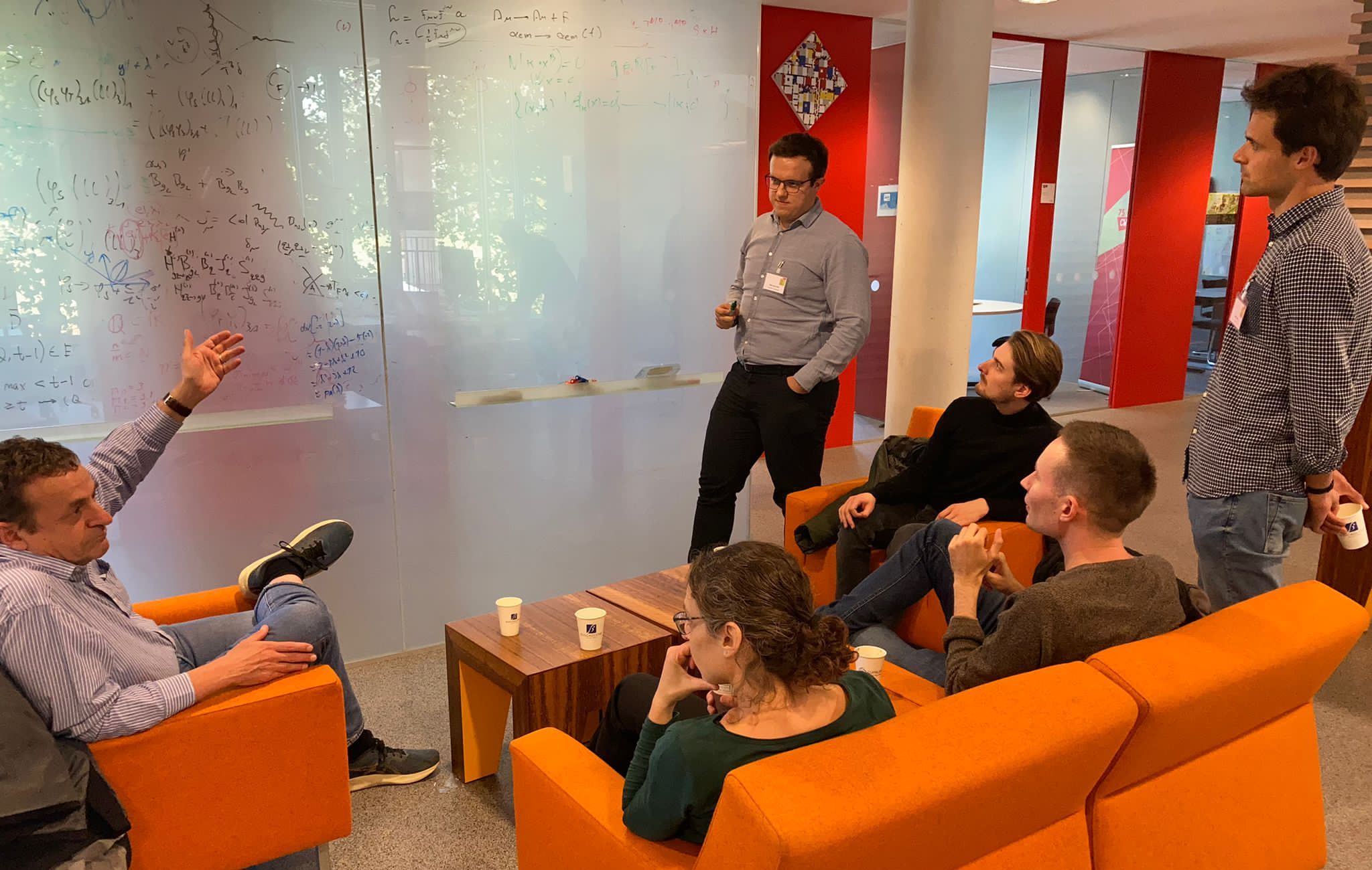 Discussion in front of a white board at CWI